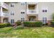 Multi-story condo building featuring well-maintained landscaping and private balconies at 17111 Doe Valley Ct, Cornelius, NC 28031