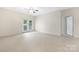 Large living room with plush carpet, neutral walls, and glass patio doors at 17111 Doe Valley Ct, Cornelius, NC 28031