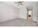 Main bedroom with neutral carpet, ceiling fan and attached bathroom at 17111 Doe Valley Ct, Cornelius, NC 28031