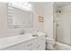 Bathroom with white vanity, sink, and walk-in shower behind glass doors at 1724 Windy Rush Ln, Gastonia, NC 28054