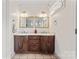 Bathroom featuring double sinks with dark cabinets and tile flooring at 1724 Windy Rush Ln, Gastonia, NC 28054