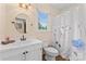 Bright bathroom features a white vanity, floral shower curtain and modern fixtures at 1724 Windy Rush Ln, Gastonia, NC 28054