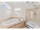 Elegant bathroom with a jacuzzi tub, a separate glass-enclosed shower, and tile flooring at 1724 Windy Rush Ln, Gastonia, NC 28054