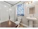 Bathroom features glass-enclosed shower, pedestal sink, and light blue accents at 1724 Windy Rush Ln, Gastonia, NC 28054