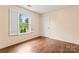 Bright bedroom features hardwood floors and a large window with verdant views at 1724 Windy Rush Ln, Gastonia, NC 28054