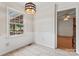 Bright breakfast nook with tiled flooring and a light fixture, next to the kitchen at 1724 Windy Rush Ln, Gastonia, NC 28054
