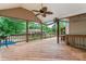 Spacious wooden deck with an outdoor fan overlooking the backyard and gazebo at 1724 Windy Rush Ln, Gastonia, NC 28054