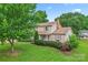 Charming two-story home with manicured lawn, lush landscaping, and inviting curb appeal at 1724 Windy Rush Ln, Gastonia, NC 28054