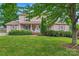 Charming home featuring lush landscaping, shutters, and a welcoming front porch at 1724 Windy Rush Ln, Gastonia, NC 28054