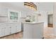 Bright kitchen with white cabinets, marble countertops, and modern stainless steel appliances at 1724 Windy Rush Ln, Gastonia, NC 28054
