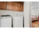Convenient laundry room equipped with modern washer and dryer, and practical storage cabinets at 1724 Windy Rush Ln, Gastonia, NC 28054