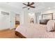 Spacious main bedroom with ceiling fan, tray ceilings, and a doorway leading to a seating area at 1724 Windy Rush Ln, Gastonia, NC 28054
