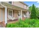 Inviting front porch featuring comfortable porch swings and chairs, perfect for relaxing outdoors at 1724 Windy Rush Ln, Gastonia, NC 28054
