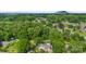 A serene aerial view of a home nestled among mature trees in a quiet neighborhood, with mountain views at 1822 N New Hope Rd, Gastonia, NC 28054