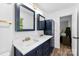 Updated bathroom boasts double vanity with gold accents and fixtures, framed mirrors, and storage at 1822 N New Hope Rd, Gastonia, NC 28054