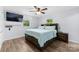 Bright bedroom featuring a ceiling fan, wood-look floors, and a large bed with built-in storage at 1822 N New Hope Rd, Gastonia, NC 28054