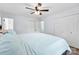 Large bed with blue comforter, wood-look floors, and double closets in this comfortable bedroom space at 1822 N New Hope Rd, Gastonia, NC 28054