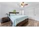 A bedroom is illuminated by a ceiling fan and features wood-look floors and a spacious bed with storage drawers at 1822 N New Hope Rd, Gastonia, NC 28054