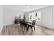 Bright dining room featuring light wood flooring, modern furniture, and a large window overlooking the yard at 1822 N New Hope Rd, Gastonia, NC 28054