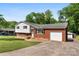 Charming home featuring a brick and white siding exterior, lush lawn, and a paved driveway at 1822 N New Hope Rd, Gastonia, NC 28054