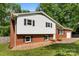 Two-story brick and siding home with well-maintained lawn and charming landscaping in a quiet neighborhood at 1822 N New Hope Rd, Gastonia, NC 28054