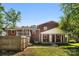 Backyard view of a charming brick home, showcasing a covered porch and well-maintained yard at 1822 N New Hope Rd, Gastonia, NC 28054