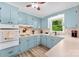 Charming kitchen features blue cabinets, wood floors, and a window offering natural light at 1822 N New Hope Rd, Gastonia, NC 28054