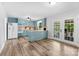 Spacious kitchen with wood floors, light blue cabinets, and modern appliances at 1822 N New Hope Rd, Gastonia, NC 28054