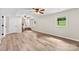 Open living room with light wood flooring, ceiling fans, and bright natural light from the windows at 1822 N New Hope Rd, Gastonia, NC 28054