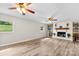 Spacious living room featuring wood-look flooring, windows with outdoor views, and modern ceiling fans at 1822 N New Hope Rd, Gastonia, NC 28054