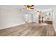 Open living room with wood flooring, ceiling fans, and access to a bathroom through a white door at 1822 N New Hope Rd, Gastonia, NC 28054