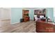 Office featuring wood floors, desk, built-in bookcase and a modern white office chair at 1822 N New Hope Rd, Gastonia, NC 28054