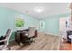 Bright office space featuring wood floors, a desk with office chair and a view to the bathroom at 1822 N New Hope Rd, Gastonia, NC 28054