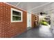 Outdoor porch area showcasing a brick house with comfortable seating and a ceiling fan at 1822 N New Hope Rd, Gastonia, NC 28054
