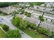 An aerial view of a townhouse community with mature trees, streets and a road nearby, showing neighborhood layout and greenery at 18460 W Catawba Ave, Cornelius, NC 28031