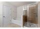 Clean bathroom with a tub, a shower, and a glass door at 18460 W Catawba Ave, Cornelius, NC 28031