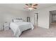 Neutral bedroom featuring a ceiling fan, carpet, and a door leading to an attached bathroom at 18460 W Catawba Ave, Cornelius, NC 28031