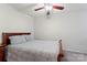 Cozy bedroom features neutral carpet, wood trim bed frame and ceiling fan at 18460 W Catawba Ave, Cornelius, NC 28031