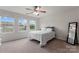 Sunlit bedroom with two windows, neutral carpeting, and a full-length mirror at 18460 W Catawba Ave, Cornelius, NC 28031