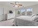 Well-lit bedroom featuring a ceiling fan, ample natural light, and white furnishings at 18460 W Catawba Ave, Cornelius, NC 28031