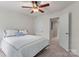 Bright bedroom with a ceiling fan and neutral carpet complemented by a white comforter and decor at 18460 W Catawba Ave, Cornelius, NC 28031