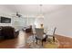 Bright dining area featuring a glass table, modern chandelier, and hardwood floors, perfect for entertaining at 18460 W Catawba Ave, Cornelius, NC 28031