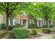 Charming brick townhome featuring a well-manicured lawn and lush greenery at 18460 W Catawba Ave, Cornelius, NC 28031