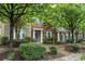 Brick townhouse with a well-manicured lawn and welcoming entrance, offering a charming and inviting curb appeal at 18460 W Catawba Ave, Cornelius, NC 28031