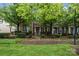 Charming brick townhome with mature trees and a well-maintained lawn, offering curb appeal at 18460 W Catawba Ave, Cornelius, NC 28031