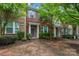 Charming brick townhome with well-maintained landscaping and a welcoming front entrance at 18460 W Catawba Ave, Cornelius, NC 28031