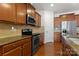 Beautiful kitchen with granite countertops, modern appliances, and warm wood cabinetry at 18460 W Catawba Ave, Cornelius, NC 28031