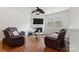 Cozy living room with comfortable seating, fireplace, and natural light, creating a relaxing atmosphere at 18460 W Catawba Ave, Cornelius, NC 28031