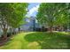 Lush backyard featuring a dining area, mature trees, and green landscaping at 189 Mills Ln, Fort Mill, SC 29708