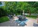Landscaped backyard featuring a dining area, fire pit, and lush greenery at 189 Mills Ln, Fort Mill, SC 29708